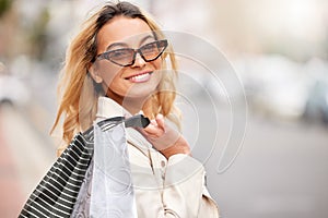 Fashion, shopping bag and portrait of woman in city with sunglasses, retail therapy and financial freedom. Smile
