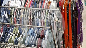 Fashion and shopping concept. Colorful women's clothes on the hangers