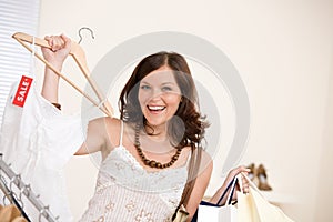 Fashion shopping - Happy woman choose sale clothes