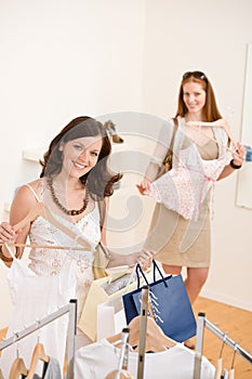 Fashion shopping - Two woman choose sale clothes