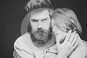 Fashion shot of couple after haircut. Hairstyle concept. Woman on mysterious face with bearded man, black background