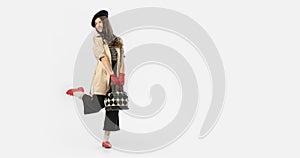 Fashion shot. Portrait of beautiful young girl, teen in retro style clothes posing at white studio background. Concept