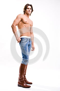 Fashion shot of a Young Man in a jeans and boots