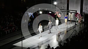 Fashion show design female clothes woman on podium close up spotlights stage 4K.