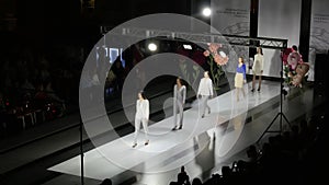 Fashion show design female clothes woman on podium close up spotlights stage 4K.