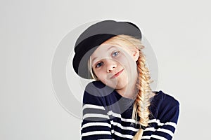 Fashion, smile and portrait of child in a studio with casual, cool and stylish outfit and hat. Happy, youth and young