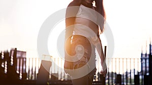 Fashion street casual with woman model with sunset on roof top garden