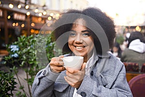 Fashion street style portrait of attractive young natural beauty African American woman with afro hair in tweed jacket