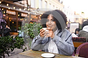 Fashion street style portrait of attractive young natural beauty African American woman with afro hair in tweed jacket