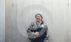 Fashion, student and gen z asian male happy, confident and . with cool clothes on wall background, smile and chilling