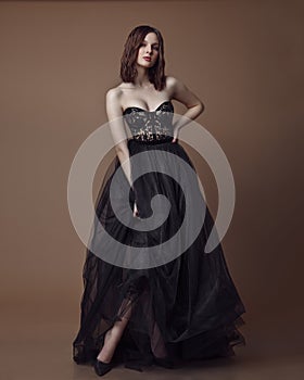 Fashion studio photo of elgant woman in long black dress