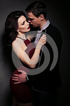 Fashion studio photo of lovely impassioned couple in elegant out