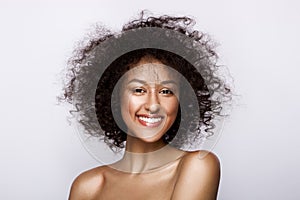 Fashion studio portrait of beautiful african american woman with perfect smooth glowing mulatto skin, make up