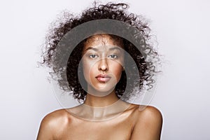 Fashion studio portrait of beautiful african american woman with perfect smooth glowing mulatto skin, make up photo