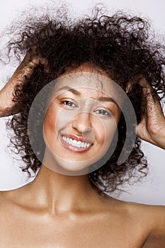 Fashion studio portrait of beautiful african american woman with perfect smooth glowing mulatto skin, make up