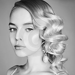 Fashion studio portrait of beautiful blonde woman with classic makeup