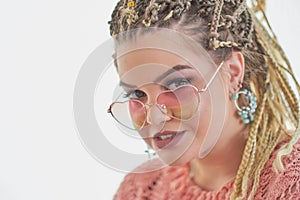 Fashion studio portrait of pretty young hipster blonde woman with bright sexy make up and glasses, White wall background