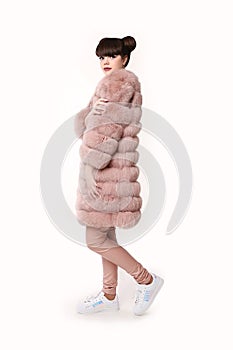 Fashion studio teen look style in pink fur coat and trendy shoes