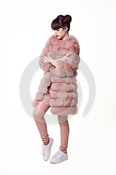 Fashion studio teen look style in pink fur coat and trendy shoes