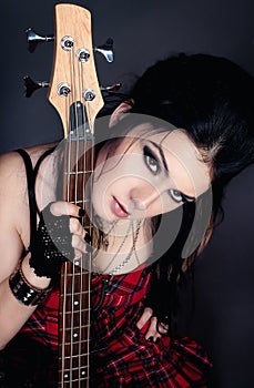 Fashion style photo of young woman with guitar