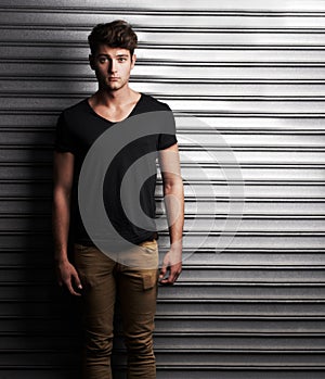 Fashion, style and portrait with man on wall background for student, trendy and casual. Cool, mockup and handsome with