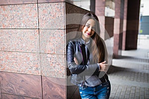 Fashion style portrait of young happy smiling beautiful elegant woman walking at city streets.