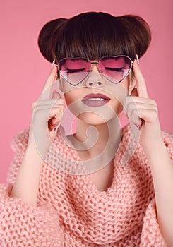 Fashion style teen girl model. Brunette in heart sunglasses with