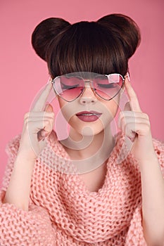 Fashion style teen girl model. Brunette in heart sunglasses with