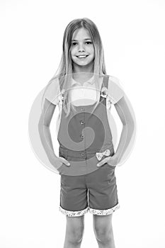 Fashion style and trend. Small girl smile in pink jumpsuit isolated on white. Child smiling with long blond hair. Kid