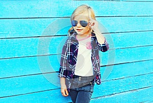 Fashion stylish child wearing a sunglasses and checkered shirt