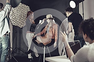 Fashion stylist with model at photoshoot photo