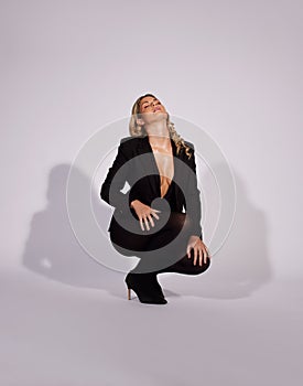 Fashion, suit and woman with confidence in studio isolated on a white background mockup space. Style, aesthetic and