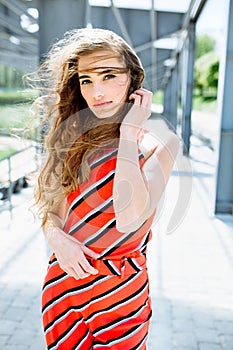 Fashion summer is a bright portrait of a young beautiful woman with long hair and colorful clothes