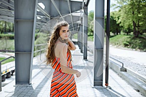 Fashion summer is a bright portrait of a young beautiful woman with long hair and colorful clothes