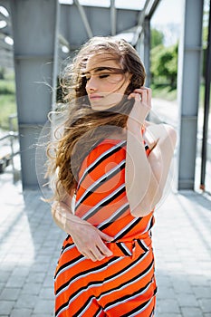 Fashion summer is a bright portrait of a young beautiful woman with long hair and colorful clothes