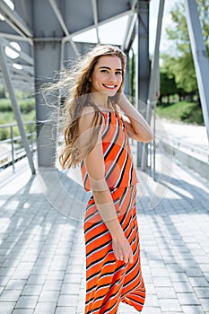 Fashion summer is a bright portrait of a young beautiful woman with long hair and colorful clothes