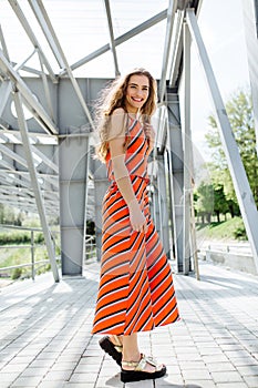 Fashion summer is a bright portrait of a young beautiful woman with long hair and colorful clothes