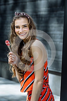 Fashion summer is a bright portrait of a young beautiful woman with long hair and colorful clothes