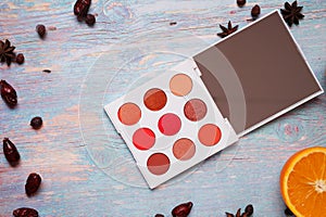 Fashion summer eye palettes with  fruit and herbs at blue wooden background. close up