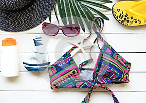 Fashion summer swimsuit bikini, sunglasses and big hat on rope. Summer bikini and accessories stylish outfit beach set. Ocean sea