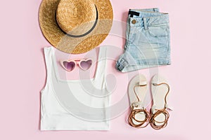 Fashion summer women`s clothes set with accessories on pink background