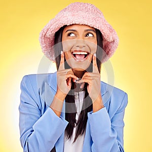 Fashion, thinking and face of woman on yellow background with funny, goofy and playful expression. Emoji, happiness and