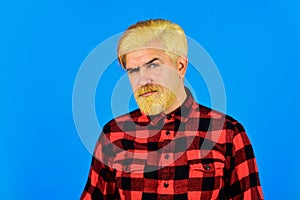 Fashion trend. Bearded man checkered shirt. Hipster dyed beard. Hairdresser and barbershop. Coloring beard. Expression photo