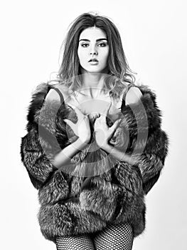 Fashion trend. Girl temptress wear stockings and fur coat. Woman posing lingerie fur jacket. Fashion boutique concept photo