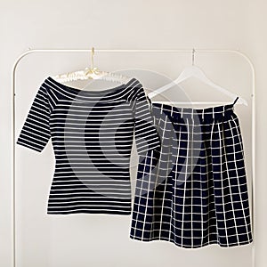 Fashion trend stripes. Blue top striped and blue skirt in cell.