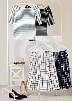 Fashion trend stripes. White and blue striped tops, blue and white skirts in cell.