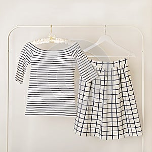 Fashion trend stripes. White striped top and white skirt in cell