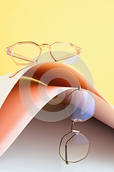 fashion trendy eyes glasses for correcting vision on a creative background, wave from paper, colorful background