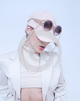 Fashion Urban Girl. Stylish Details of everyday outfit. Casual beige aesthetics.Trendy accessories velvet cap and sunglasses,