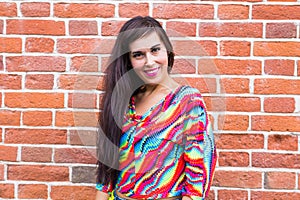 Fashion and urban style concept - Portrait of a beautiful woman in blue jeans against a white brick wall with copy space